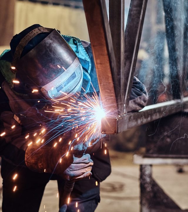 Man is working at the busy metal factory